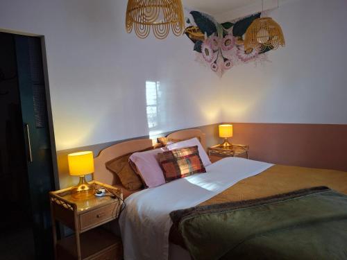 a bedroom with a bed and two lamps on tables at Jesmond B&B Kingsize Ensuite Room 2 in Hull