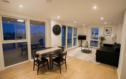 a living room with a table and a couch at Waterfront- London Greenwich o2 Arena 2 Bed Flat in London
