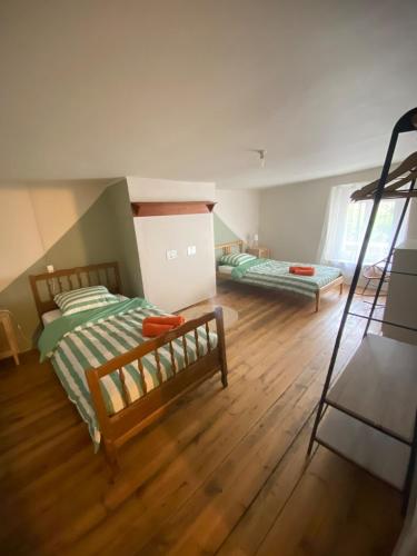 a bedroom with two bunk beds and a ladder at Maison Basse in Malestroit