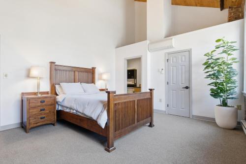 a bedroom with a bed and a potted plant at Gorgeous downtown apartment with loft in Hartford