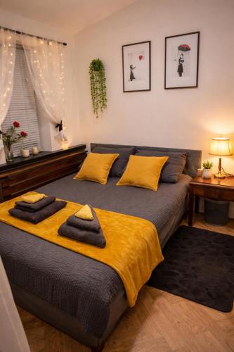 a bedroom with a bed with two towels on it at Luxury Smart Apartment Slough, Sleeps 5, Garden, Parking, Spa-Style Bathroom in Slough