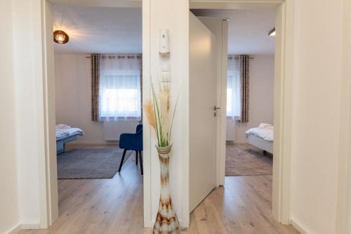 a hallway with a vase of flowers in a room at Ferienwohnung am Buttermarkt in Adenau