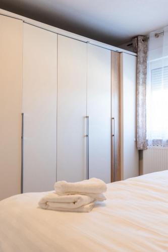 a bedroom with a bed with white wardrobes at Ferienwohnung am Buttermarkt in Adenau