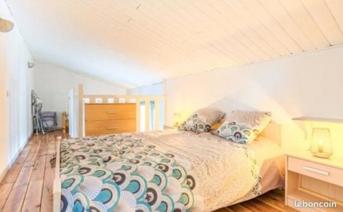 a bedroom with a bed and a wooden floor at Gîte in Avanton