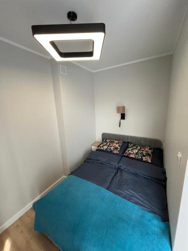 a bedroom with a bed and a ceiling fan at Apartament Calisia II in Kalisz