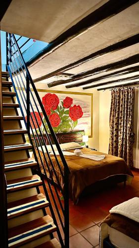 a bedroom with a bed with a painting of roses at MONTESANO Finca HOTEL in Jenesano