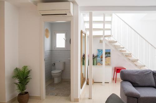 a bathroom with a toilet and a staircase at Villa Paula Trinidad in Salou