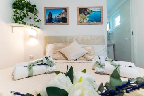 a bedroom with a bed with towels on it at B&B Morrocoy Beach in Marina di Camerota