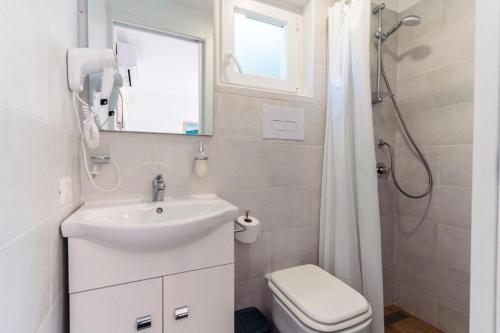a bathroom with a sink and a toilet and a shower at B&B Morrocoy Beach in Marina di Camerota