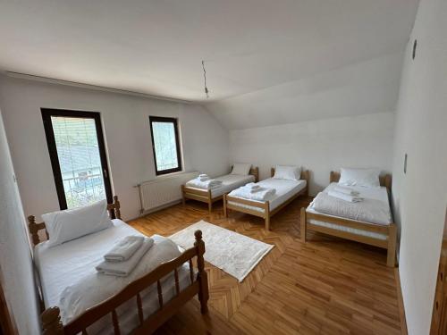 a room with two beds and two chairs in it at Highland guest house Vuthaj in Vusanje