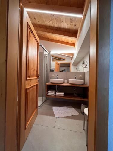 a bathroom with two sinks and a mirror at Biobauernhof Windbachgut in Eben im Pongau