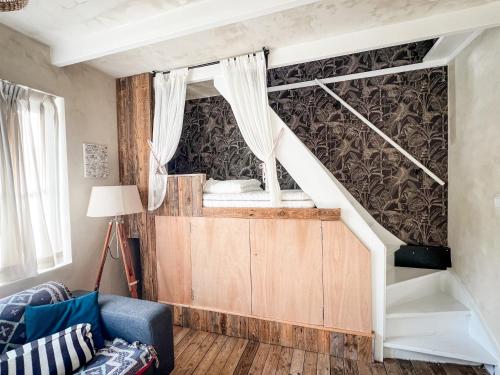 a room with a bunk bed and a staircase at Cottage Rose in Bergen