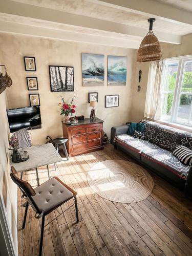 a living room with a couch and a table at Cottage Rose in Bergen