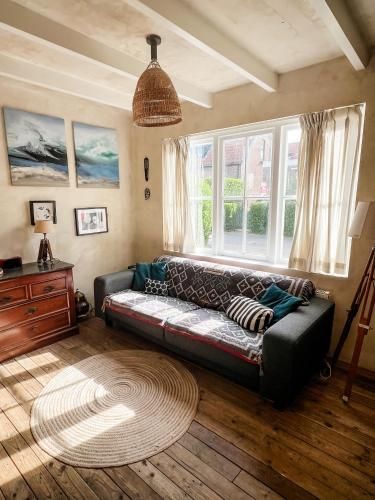 a living room with a couch and a window at Cottage Rose in Bergen