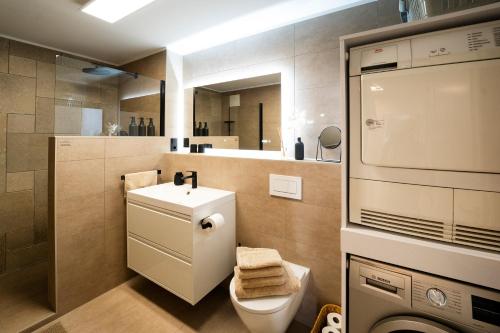 a bathroom with a toilet and a sink and a mirror at Ferienwohnung RaiKa in Moers
