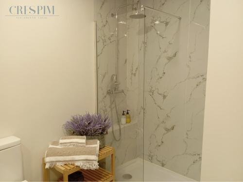 a shower with a glass door in a bathroom at Casa Crespim in Monção