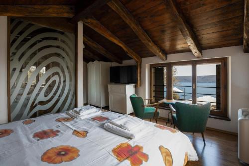 a bedroom with a bed and a table with chairs at Refugio Ivanini in Zagorje