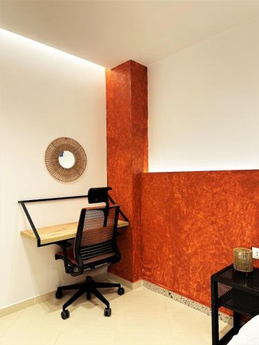 an office with a desk and a chair in a room at DuoNest-BoHo Sunset in Tirana