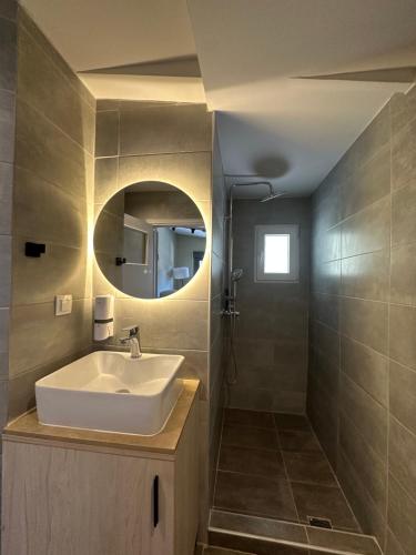a bathroom with a sink and a mirror at Pine and Sea in Artemida