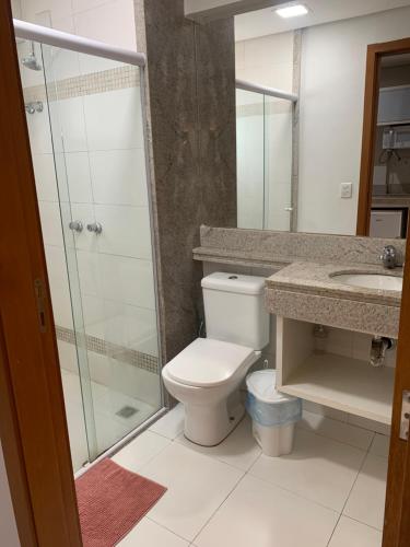 a bathroom with a toilet and a shower and a sink at Prime Flats in Palmas
