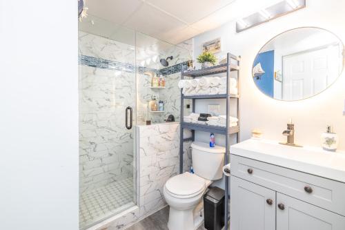 a bathroom with a shower and a toilet and a sink at Casa Del Mar 231 - Ocean View Family Retreat on Seawall in Galveston