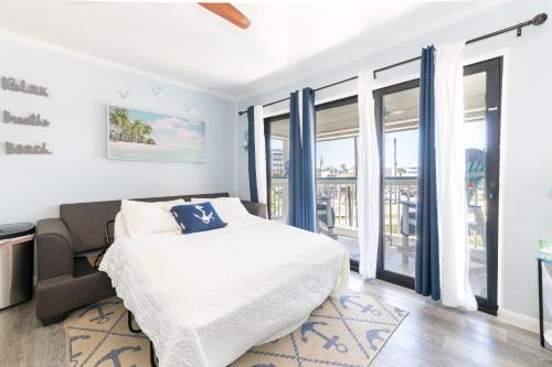 a bedroom with a bed and sliding glass doors at Casa Del Mar 231 - Ocean View Family Retreat on Seawall in Galveston