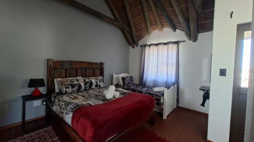 a bedroom with a bed and a chair in it at Shelley Point Townhouse in Stompneusbaai