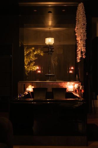a room with a table with candles and a mirror at Suite romantique avec Balneo et jeux coquins in Roanne
