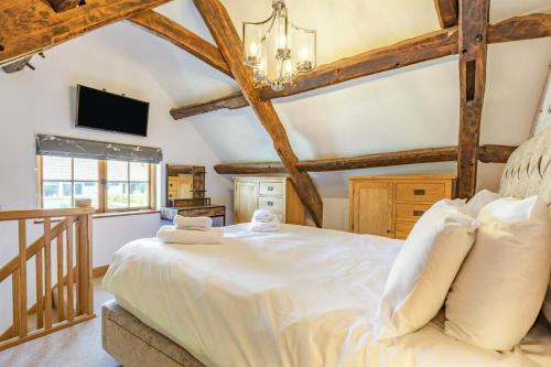 a bedroom with a large bed and a tv at 3 Bed in Croyde oc-s27761 in Croyde