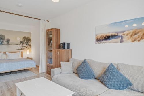 a living room with a couch and a bed at Berolina C 106 in Dahme