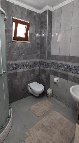 a bathroom with a toilet and a sink at Bıyıklı House in Akcaabat
