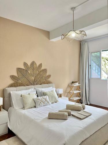a bedroom with a large white bed with pillows at Meu Quintal 4, Calheta-Madeira in Calheta
