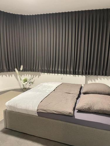 a bed in a room with a large window at Ferienwohnung Alina in Werne an der Lippe
