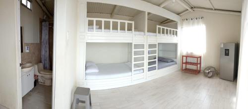 two bunk beds in a room with a bathroom at VistamarGrau in Caleta Grau
