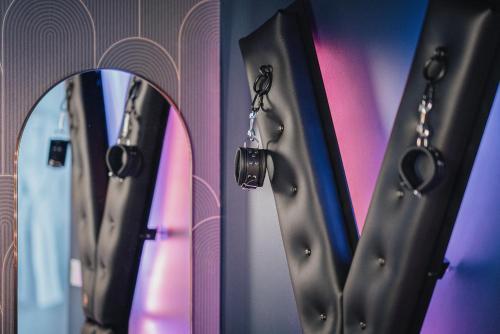 a row of mirrors on a wall next to a mirror at L'Eure de Luxure Loveroom Suite in Normandy in Évreux