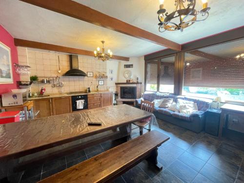 a kitchen and living room with a table and a couch at MyG-BarriAlto in Cirueña