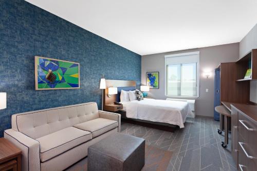 a hotel room with a bed and a couch at Home2 Suites By Hilton Temecula in Temecula