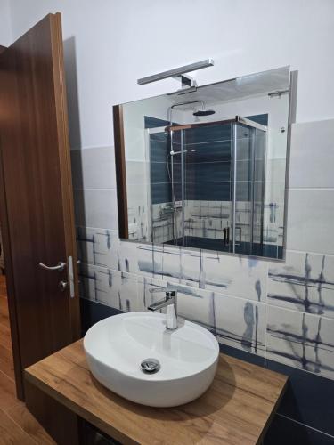 a bathroom with a white sink and a mirror at Borgo Cipampini in Petralia Soprana