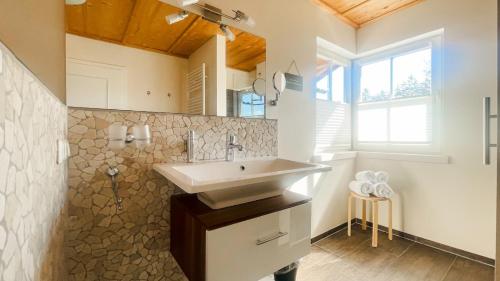 a bathroom with a sink and a mirror at Kaiser's Landhaus in Schliersee