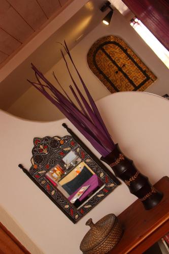 a mirror on a shelf with an umbrella at Maison d'hôtes L'îlot bambou in Avignon
