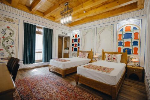 a bedroom with two beds in a room at Imranbek Boutique Hotel in Bukhara