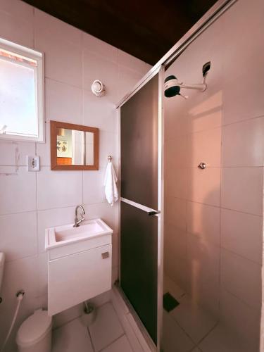 a bathroom with a shower and a toilet and a sink at Pousada bella mar buzios in Búzios
