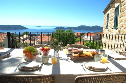 a table with a plate of food on a balcony at Heritage house Stone Orchard, near Dubrovnik in Orasac