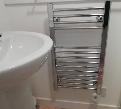 a bathroom with a white toilet and a sink at Heaven Above the Haven in Millport