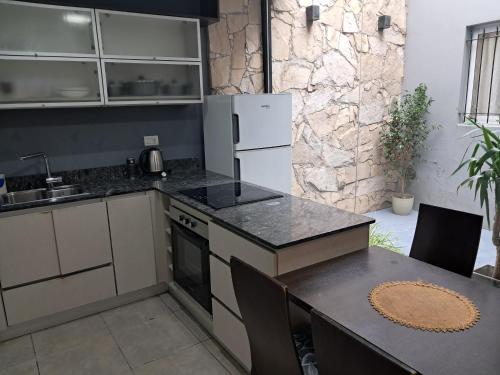 a kitchen with a refrigerator and a table with chairs at Residencial 43 in La Plata