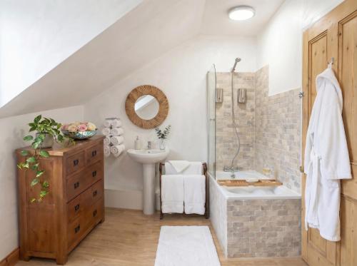 a bathroom with a shower and a sink and a tub at Burlington Palace Eastbourne Seafront Villa with Garden. in Eastbourne