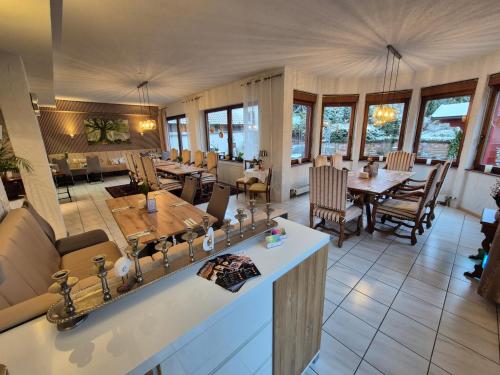 a large living room with tables and chairs at Landhotel Schönblick in Bad Herrenalb