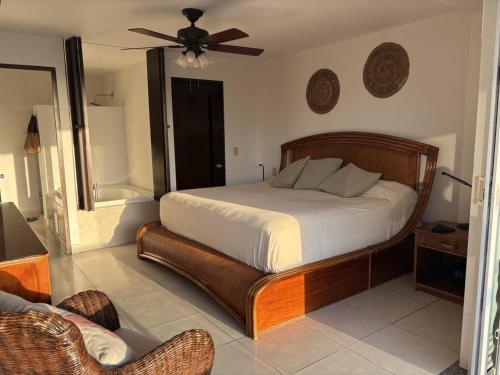 a bedroom with a bed and a ceiling fan at Villa Magna in Nuevo Vallarta