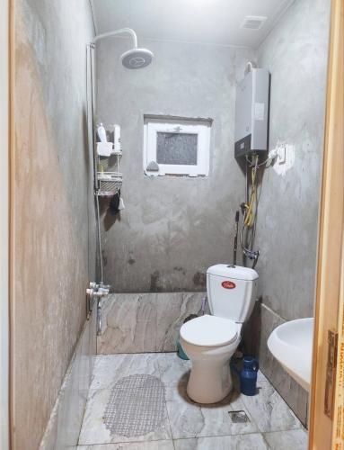 a bathroom with a toilet and a sink at happy star stay in Sheki