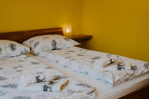 a bedroom with two beds with towels on them at Apartment Konavec in Kobarid